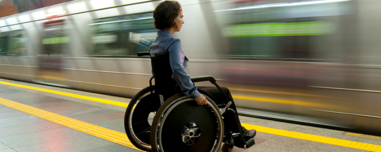Woman in a wheelchair waiting for the subway