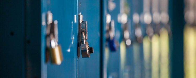 Close up photograph of blue school lockers with locks on them.
