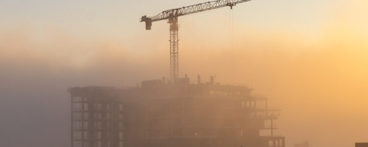 Fog blanket moving in at sunset over a construction site and crane in Toronto Ontario