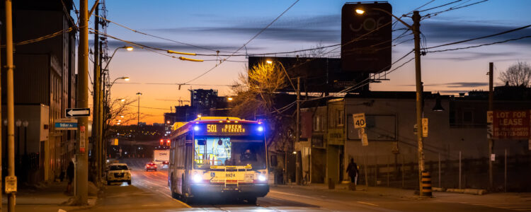 A 501 Toronto city bus just after sunset heading from Queen to Church