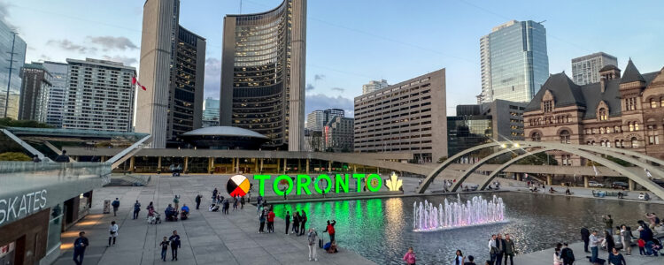 Nathan Phillips Square with Toronto City Hall in the background at dusk