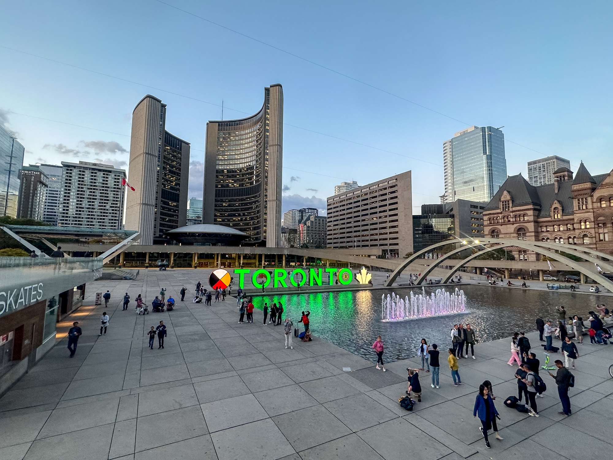 Nathan Phillips Square with Toronto City Hall in the background at dusk